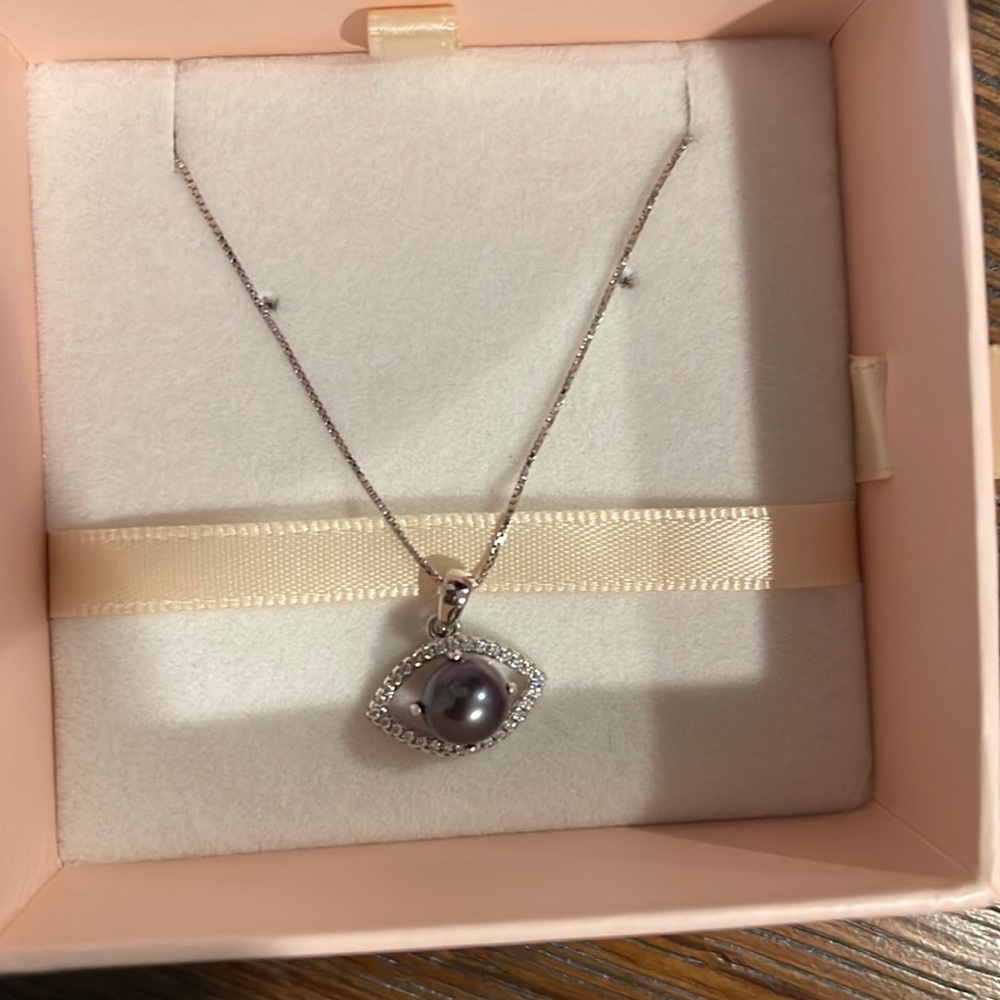 Genuine peacock Pearl with eye charm on necklace